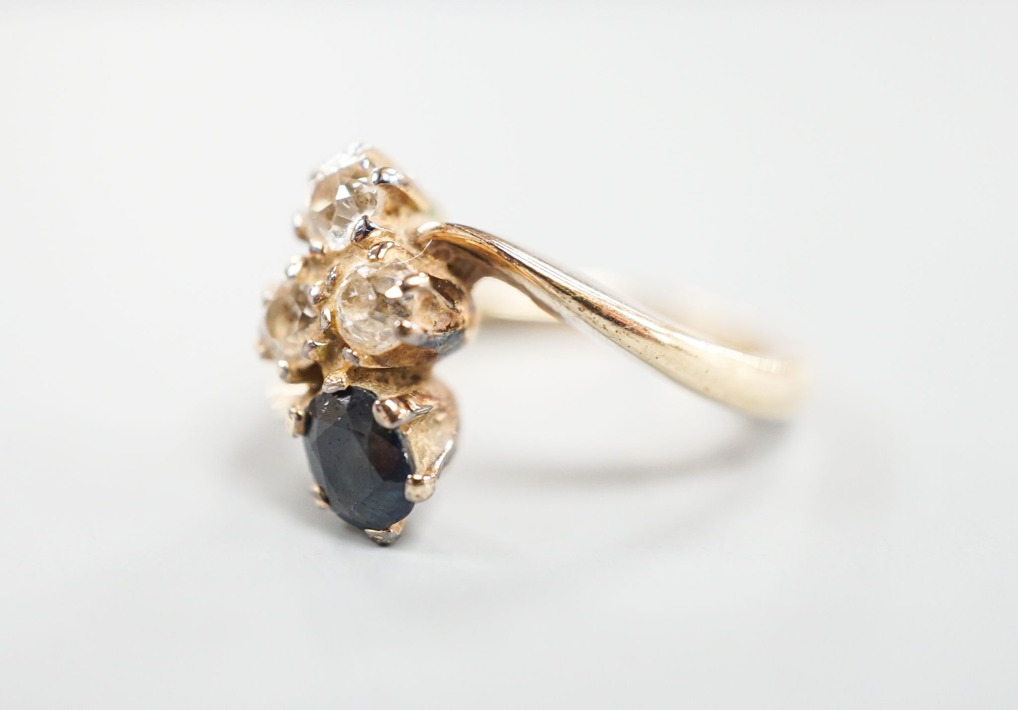A yellow metal, sapphire an diamond set four stone dress ring, size L, gross 3.4 grams.